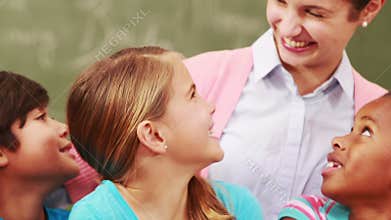 Teacher and pupils looking at laptop