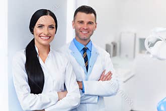 Dentist Team at Dental Clinic. Two Smiling Doctors at their Work