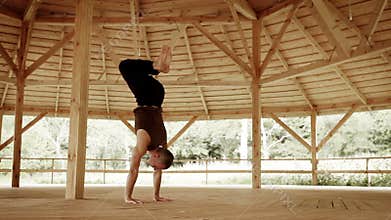 Professional yoga teacher shows Smooth handstand in high mountain trauning cente