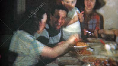 1951: Big family at crowded dinner table eat Italian food. NEWARK, NEW JERSEY