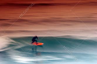 Surfer catching the wave