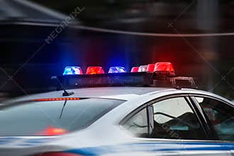 Police car rushes to the emergency call with lights turned on