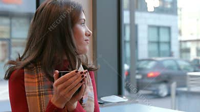 Pretty brunette enjoying coffee in cafe