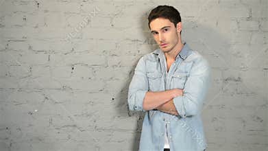 Male posing in a denim and a white T-shirt