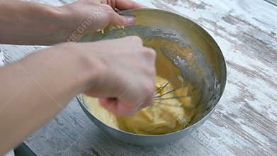 Preparation of cake. Corolla mixing dough. Close