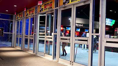 Close up door of people leaving and coming the movie theater