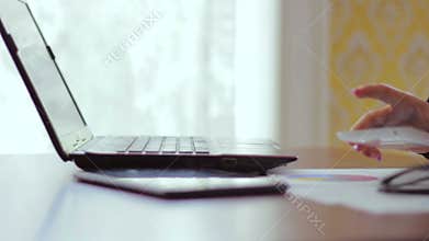 Closeup of a hand of the girl working behind the