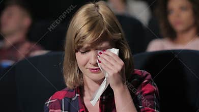 Girl with blue eyes crying during the movie