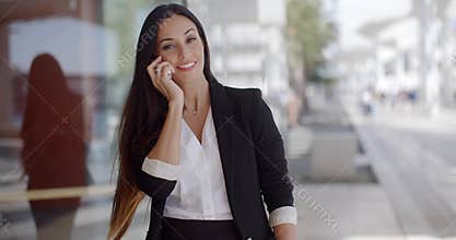 Thoughtful gorgeous woman chatting on a mobile