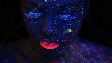 Woman face with fluorescent make up