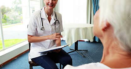 Nurse talking with a patient senior woman