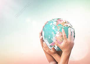Multiple Diverse Hands Cradling Planet Earth against Bright Ethereal Nature Background