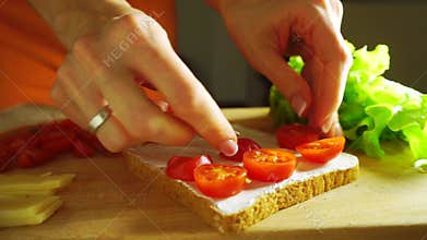 Making a sandwich: putting cherry tomatoes on bread