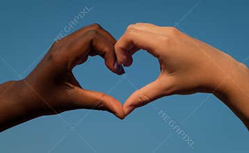 Black and white hands in heart shape, interracial friendship concept