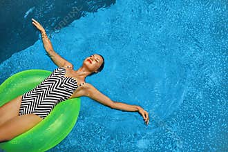 Summer Vacations. Woman Sunbathing, Floating In Swimming Pool Water