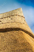 Apex of a freshly thatched cottage roof