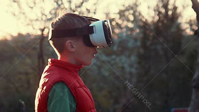 Little boy use virtual reality headset helmet