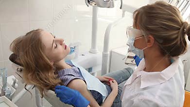 Female Dentist with Tools Checking Patient Teeth up