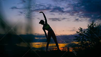 Carefree woman dancing in the sunset. vacation vitality healthy living concept.