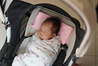 Close up of 1 month old baby in pram
