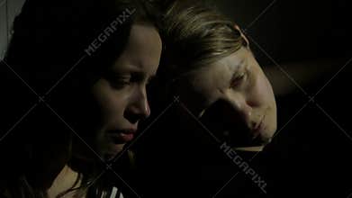 Two girls holding each other. Sisters or mother and daughter or friends. 4K UHD