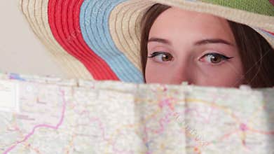 Woman's face behind a map.