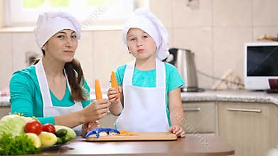 Child with mum clean carrots