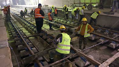Underground subway tunnel workers pouring concrete