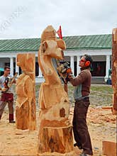 Making wooden sculptures with the help of an axe and a saw/