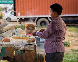 A young man making a tea