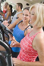 Personal Trainer Instructing Woman On Treadmill