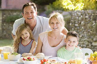 Family Enjoying A Barbeque