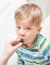Сhild taking cough syrup