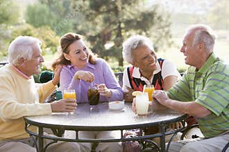 Friends Enjoying A Beverage By A Golf Course