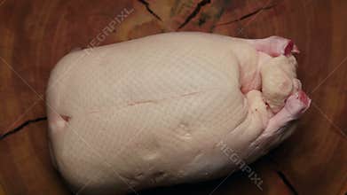 Raw duck on a wooden table ready to be cooked