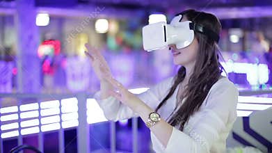 Young woman is happy in virtual reality glasses. VR.