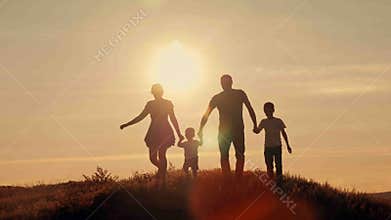 Happy family on sunset silhouette