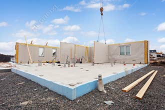 Building the energy efficient house. Structural insulated panels with plastic tubes in foundation.