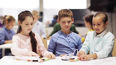 Happy children learning at robotics school