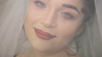 Face of the young beautiful bride under the white wedding veil