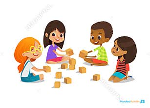 Laughing and smiling kids sit on floor in circle, play with toy cubes talk.
