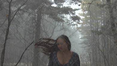 Young girl in fear running through the woods.