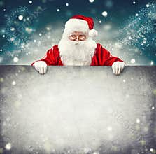 Santa Claus holding blank advertisement banner
