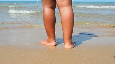 Kid standing water edge summer