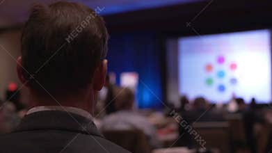 Man listens at a conference