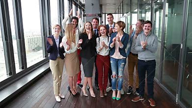 Portrait of happy business and advertising team laughing and clapping