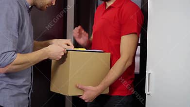 Home delivery service - man signing receipt of package