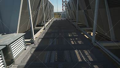 Camera moves between the rows of the equipment of the ventilation system. On the roof of an industrial building has a