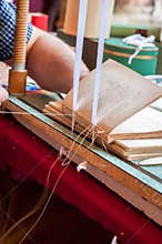 Bookbinding. Male worker binding pages.