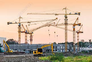 Building construction site with tower crane machinery